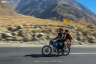 Panning shot of bikers on the Karakoram Highway in Gilgit Baltistan